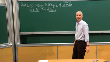 Supersymmetry, differential operators of infinite order and theta-functions