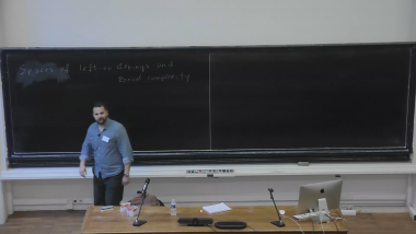 Spaces of left-orderings and their Borel complexity