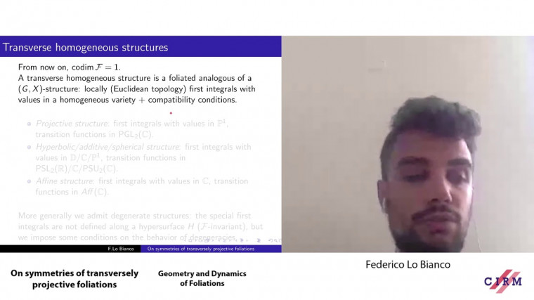 On symmetries of transversely projective foliations