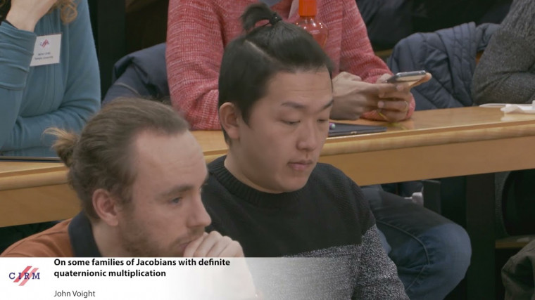 On some families of Jacobians with definite quaternionic multiplication