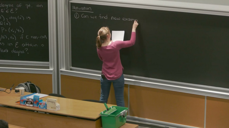 Minimal torsion curves in geometric isogeny classes