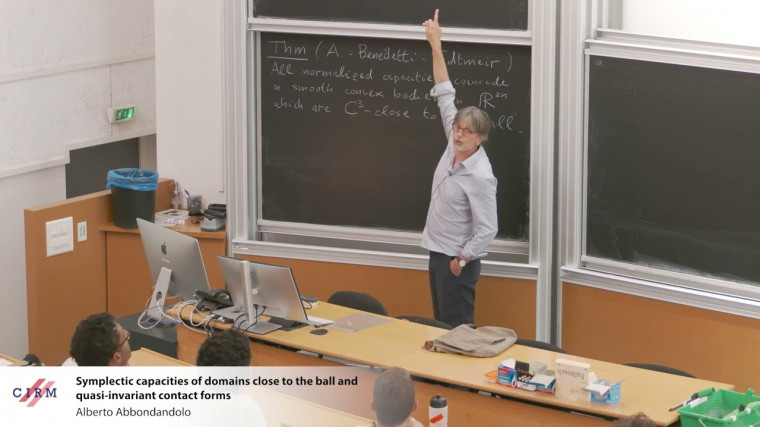 Symplectic capacities of domains close to the ball and quasi-invariant contact forms