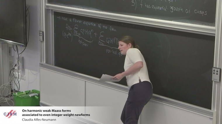 On harmonic weak Maass forms associated to even integer weight newforms