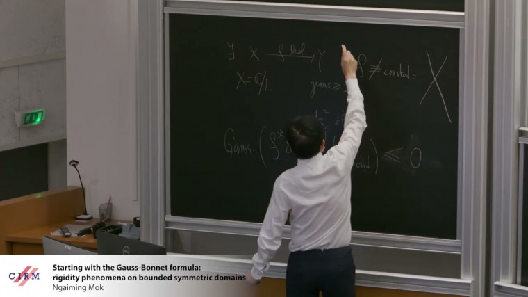 Starting with the Gauss-Bonnet formula: rigidity phenomena on bounded symmetric domains