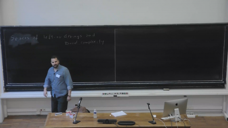 Spaces of left-orderings and their Borel complexity